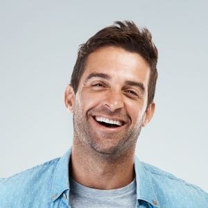 Smiling man wearing denim shirt